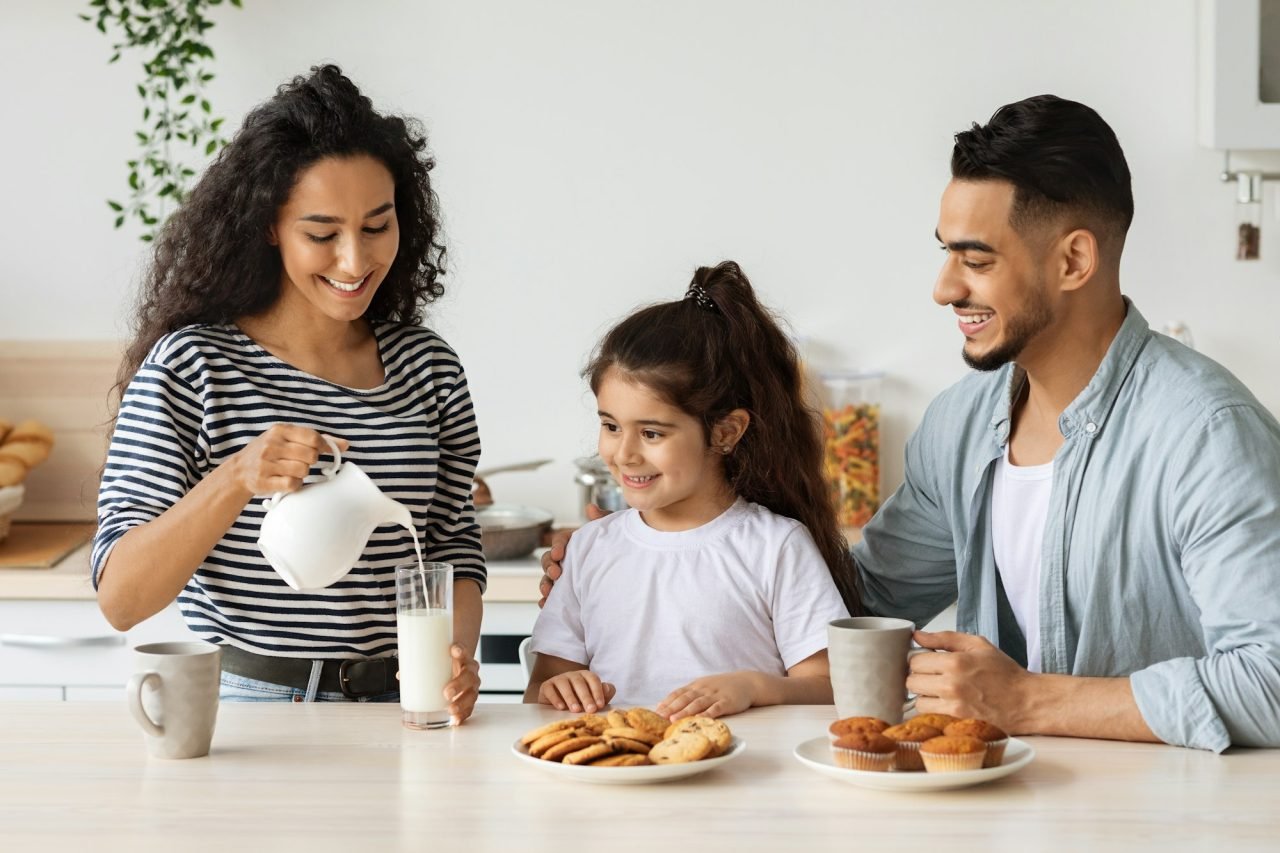 loving-mother-pouring-milk-for-her-cute-little-daughter.jpg